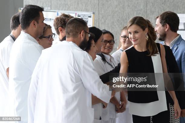 Spain's Queen Letizia shakes hands with medicall staff after visiting victims of the Barcelona attack at the Sant Pau hospital in Barcelona after on...