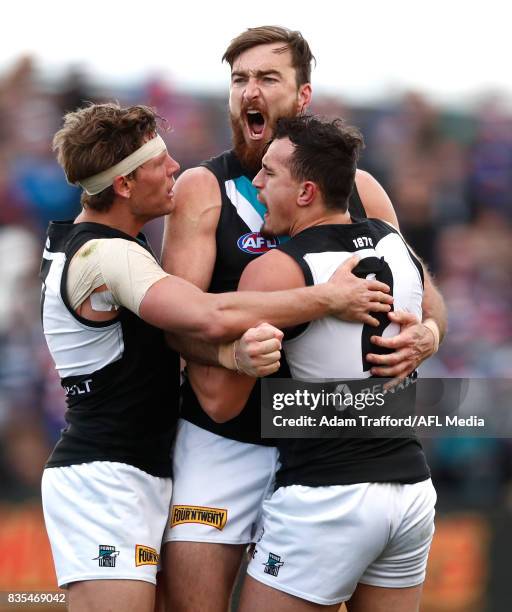 Charlie Dixon of the Power celebrates a goal with Brad Ebert and Sam Powell-Pepper of the Power during the 2017 AFL round 22 match between the...