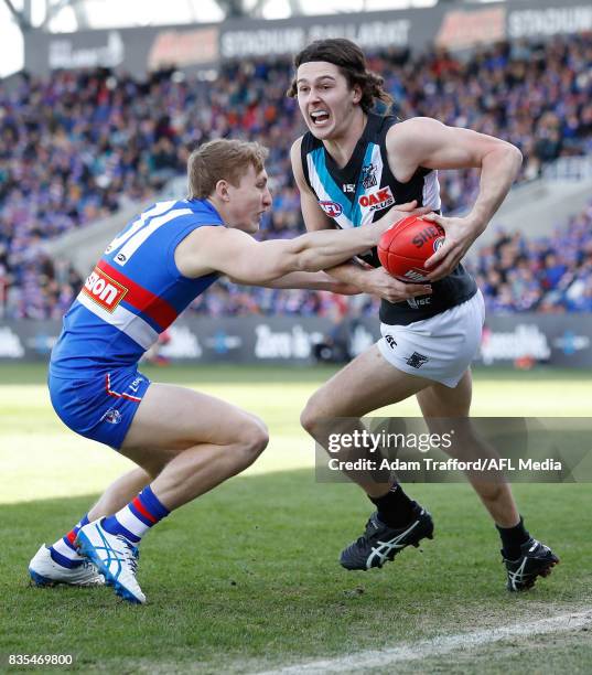 Darcy Byrne-Jones of the Power is tackled by Bailey Dale of the Bulldogs during the 2017 AFL round 22 match between the Western Bulldogs and the Port...