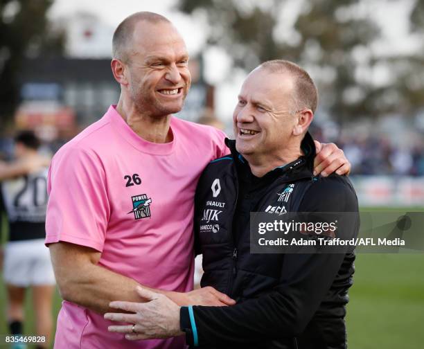 Ken Hinkley, Senior Coach of the Power celebrates with Chad Cornes during the 2017 AFL round 22 match between the Western Bulldogs and the Port...