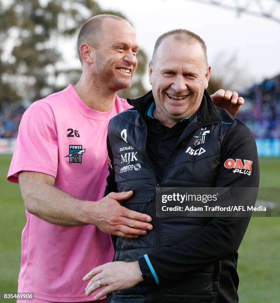Ken Hinkley, Senior Coach of the Power celebrates with Chad Cornes during the 2017 AFL round 22 match between the Western Bulldogs and the Port...