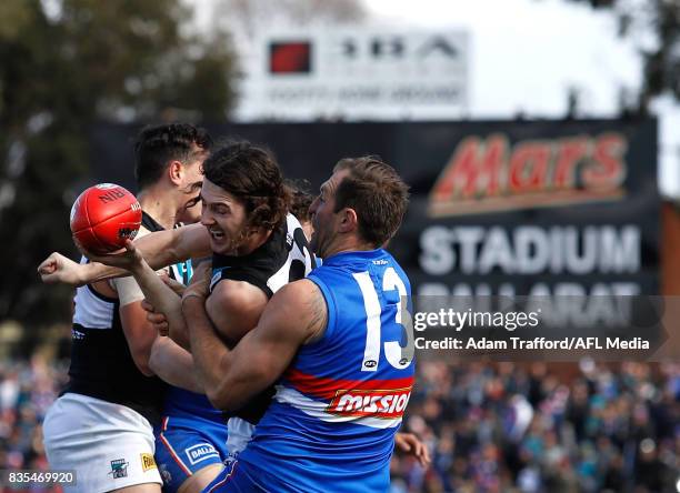 Darcy Byrne-Jones of the Power is tackled by Travis Cloke of the Bulldogs during the 2017 AFL round 22 match between the Western Bulldogs and the...