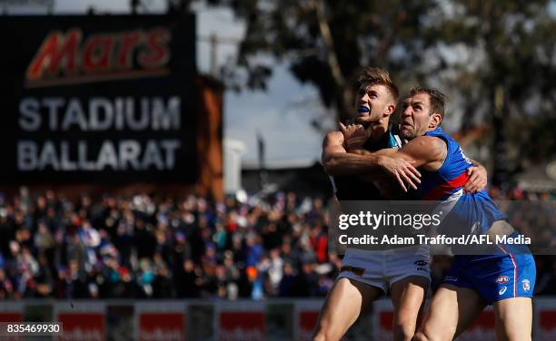 Dougal Howard of the Power and Travis Cloke of the Bulldogs compete for the ball during the 2017 AFL round 22 match between the Western Bulldogs and...