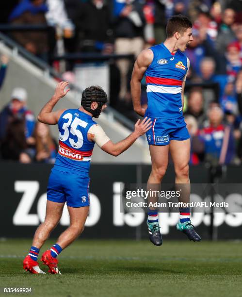 Josh Dunkley of the Bulldogs celebrates a goal with Caleb Daniel of the Bulldogs during the 2017 AFL round 22 match between the Western Bulldogs and...