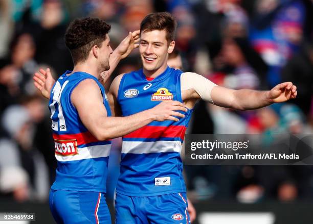 Josh Dunkley of the Bulldogs celebrates a goal with Tom Liberatore of the Bulldogs during the 2017 AFL round 22 match between the Western Bulldogs...