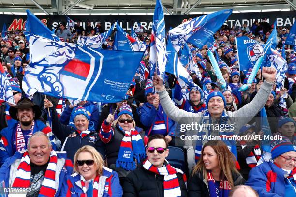 Bulldogs fans wave their flags during the 2017 AFL round 22 match between the Western Bulldogs and the Port Adelaide Power at Mars Stadium on August...