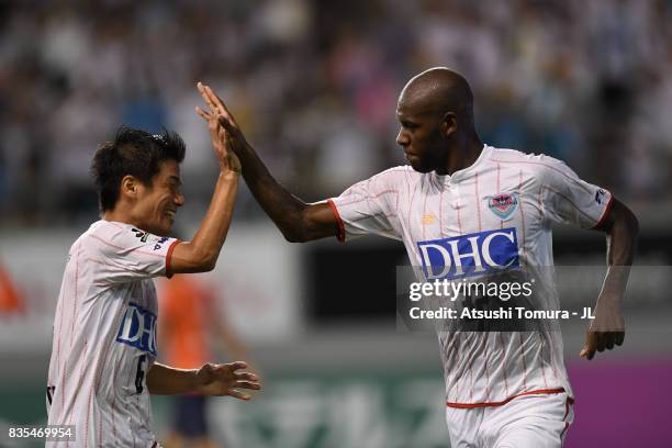 Victor Ibarbo of Sagan Tosu celebrates scoring the opening goal with his team mate Akito Fukuta during the J.League J1 match between Sagan Tosu and...