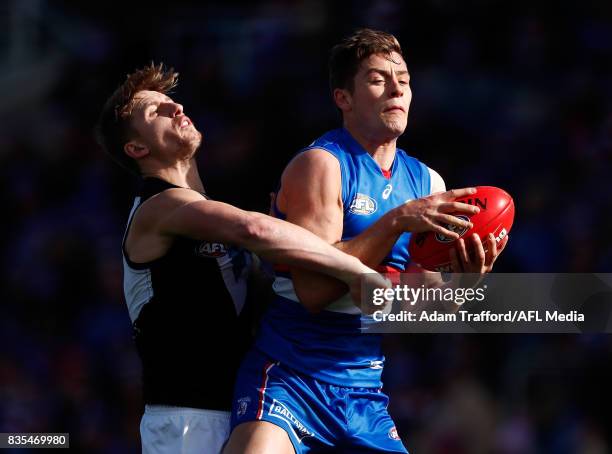 Josh Dunkley of the Bulldogs and Hamish Hartlett of the Power compete for the ball during the 2017 AFL round 22 match between the Western Bulldogs...