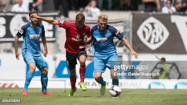 Pascal Sohm of Grossaspach is challenged by Thorsten Schulz of Aalen during the 3. Liga match between SG Sonnenhof Grossaspach and VfR Aalen at on...