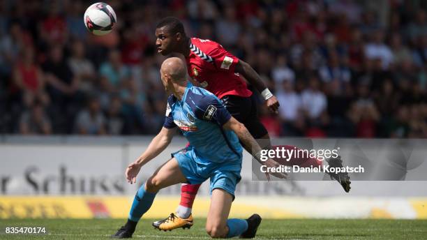 Joseph-Claude Gyau of Grossaspach is challenged by Matthias Morys of Aalen during the 3. Liga match between SG Sonnenhof Grossaspach and VfR Aalen at...