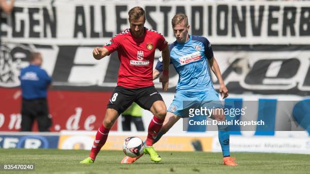 Pascal Sohm of Grossaspach is challenged by Patrick Schorr of Aalen during the 3. Liga match between SG Sonnenhof Grossaspach and VfR Aalen at on...