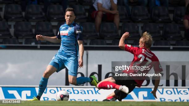 Marcel Baer of Aalen is challenged by Michael Vitzthum of Grossaspach during the 3. Liga match between SG Sonnenhof Grossaspach and VfR Aalen at on...