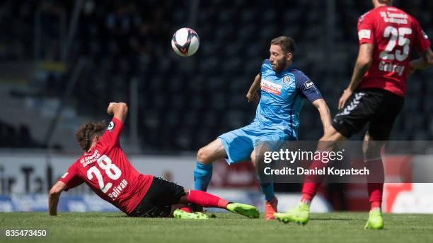 Rico Preissinger of Aalen is challenged by Dominik Pelivan of Grossaspach during the 3. Liga match between SG Sonnenhof Grossaspach and VfR Aalen at...