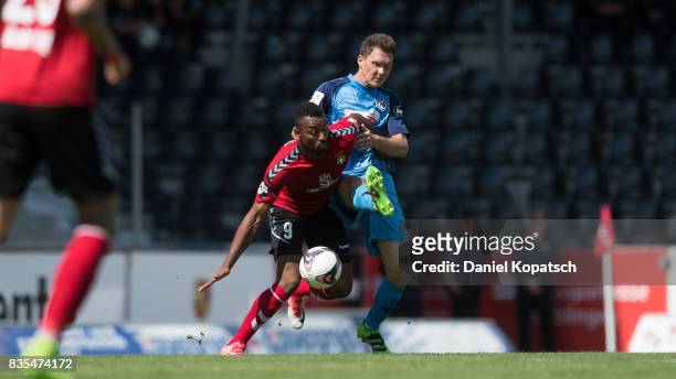 Saliou Sane of Grossaspach is challenged by Robert Mueller of Aalen during the 3. Liga match between SG Sonnenhof Grossaspach and VfR Aalen at on...