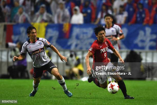 Yuki Muto of Urawa Red Diamonds and Shoya Nakajima of FC Tokyo compete for the ball during the J.League J1 match between Urawa Red Diamonds and FC...