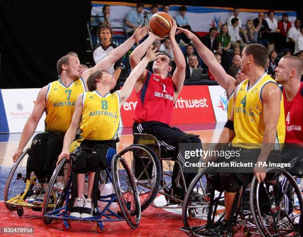 Great Britain's Ian Sagar shoots against Australia's Shaun Norris and Kim Robbins during the Wheelchair Basketball match at the Manchester Regional...