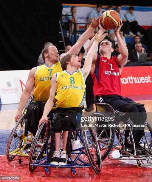 Great Britain's Ian Sagar shoots against Australia's Shaun Norris and Kim Robbins during the Wheelchair Basketball match at the Manchester Regional...