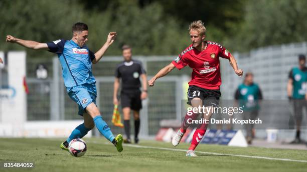 Michael Vitzthum of Grossaspach is challenged by Marcel Baer of Aalen during the 3. Liga match between SG Sonnenhof Grossaspach and VfR Aalen at on...