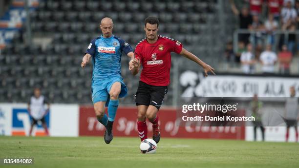 Julian Leist of Grossaspach is challenged by Matthias Morys of Aalen during the 3. Liga match between SG Sonnenhof Grossaspach and VfR Aalen at on...