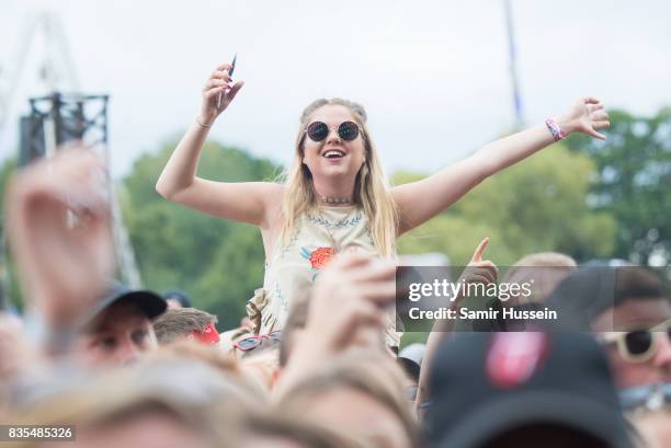Festival goers enjoy the music during V Festival 2017 at Hylands Park on August 19, 2017 in Chelmsford, England.