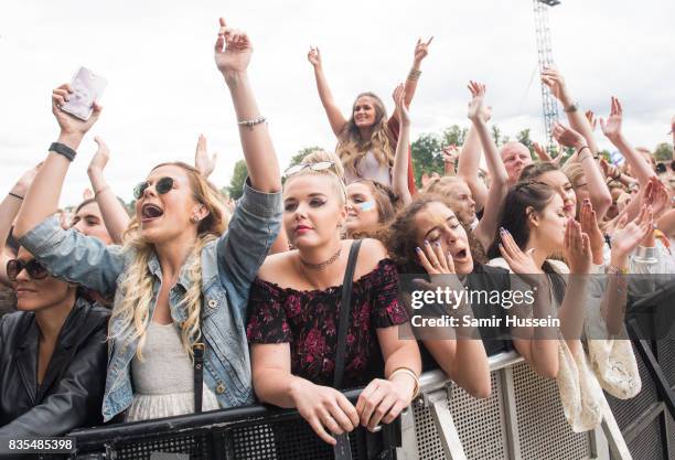 Festival goers enjoy the music during V Festival 2017 at Hylands Park on August 19, 2017 in Chelmsford, England.