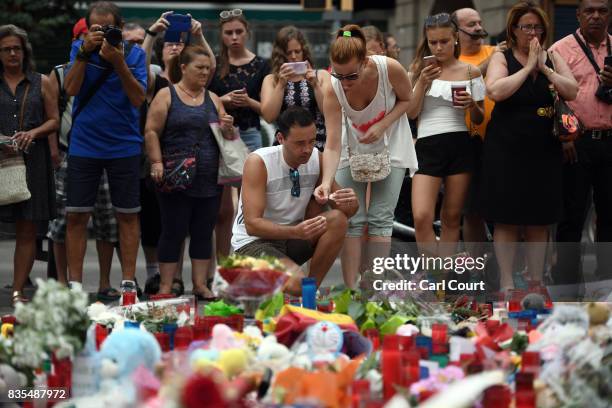 People gather around tributes on Las Ramblas near the scene of Thursday's terrorist attack, on August 19, 2017 in Barcelona, Spain. A nationwide...