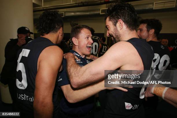 Blues head coach Brendon Bolton celebrates the win Kade Simpson of the Blues during the round 22 AFL match between the Carlton Blues and the Hawthorn...