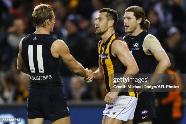 Luke Hodge of the Hawks hakes hands with a victorious Sam Kerridge of the Blues during the round 22 AFL match between the Carlton Blues and the...