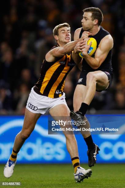 Sam Docherty of the Blues marks the ball against Ryan Schoenmakers of the Hawks during the round 22 AFL match between the Carlton Blues and the...