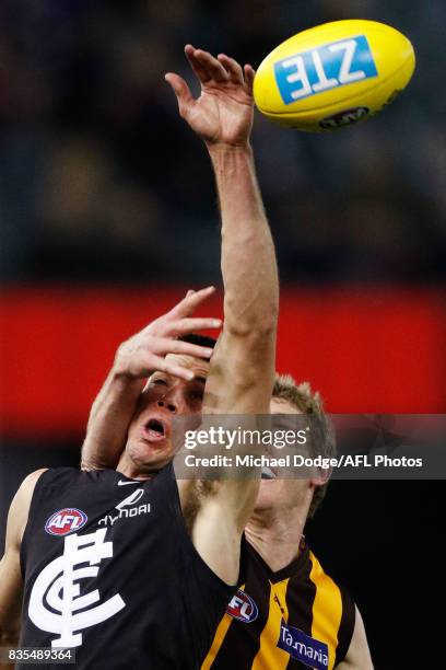 Ben McEvoy of the Hawks hits Matthew Kreuzer of the Blues in the face on this contest during the round 22 AFL match between the Carlton Blues and the...