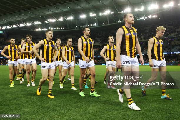 Hawks players walk off after defeat during the round 22 AFL match between the Carlton Blues and the Hawthorn Hawks at Etihad Stadium on August 19,...