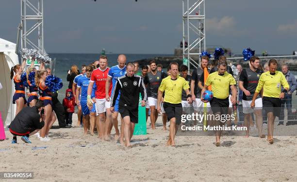 Referees and players enter the pitch on day 1 of the 2017 German Beach Soccer Championship on August 19, 2017 in Warnemunde, Germany.