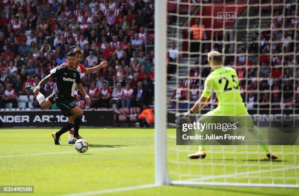 Manolo Gabbiadini of Southampton scores his sides first goal past Joe Hart of West Ham United during the Premier League match between Southampton and...