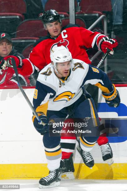 Derek Roy of the Buffalo Sabres checks Jamie Langenbrunner of the New Jersey Devils during the first period on November 3, 2008 at the Prudential...