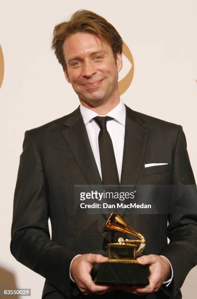 Producer Giles Martin poses in the press room with the award for Best Compilation Soundtrack Album for "Love" during The 50th Annual Grammy Awards...