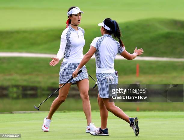 Michelle Wie and Danielle Kang of Team USA celebrate a birdie to win the third hole over Team Europe during the morning foursomes matches of the...