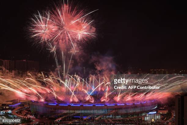 Fireworks light the sky above the Bukit Jalil National Stadium during the opening ceremony of the 29th Southeast Asian Games in Kuala Lumpur on...