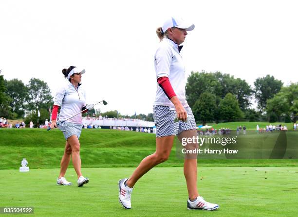 Stacy Lewis and Gerina Piller of the United States leave the third tee during the morning foursomes matches of the Solheim Cup at the Des Moines Golf...