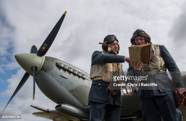 Historical reenactors and pilots Nigel Carver and George Bruckert pose for photographs next to a Spitfire at the Biggin Hill Festival of Flight on...