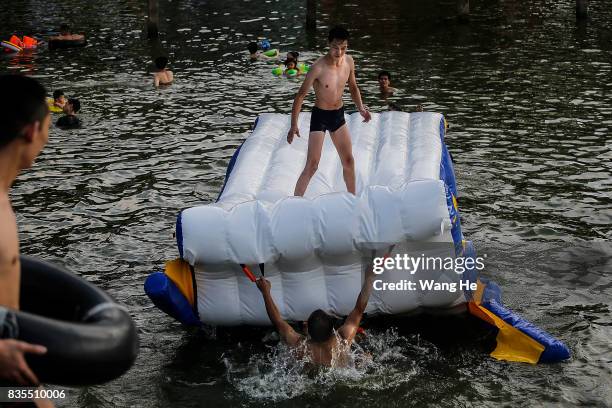 Residents enjoy the water in East Lake on August 19, 2017 in Wuhan, Hubei province, China. This activity, which requires participants to ride their...