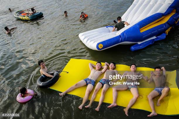 Residents enjoy the water in East Lake on August 19, 2017 in Wuhan, Hubei province, China. This activity, which requires participants to ride their...