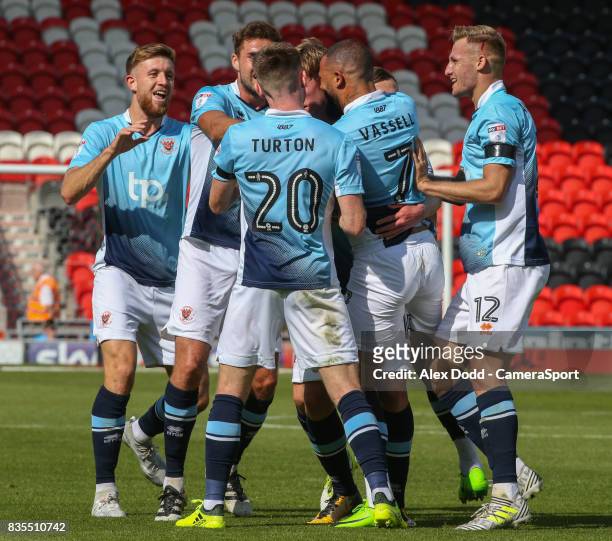 Blackpool players congratulate Sean Longstaff after his strike made the score 1-1 during the Sky Bet League One match between Doncaster Rovers and...