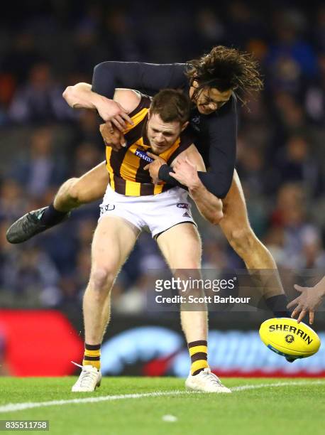 Blake Hardwick of the Hawks is tackled by Jack Silvagni of the Blues during the round 22 AFL match between the Carlton Blues and the Hawthorn Hawks...