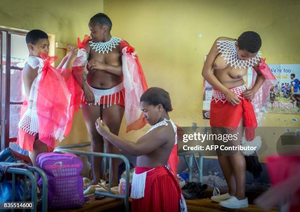 Traditionally clad Zulu maidens prepare to take part in the mini reed dance in the rural district of Emalangeni, some 80kms north of Durban on August...