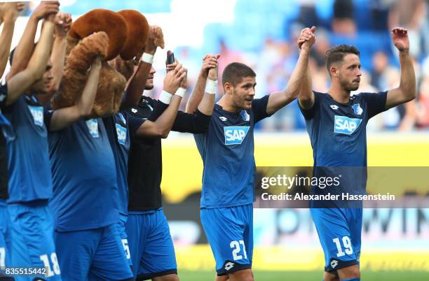 Mark Uth of TSG 1899 Hoffenheim and Andrej Kramaric of TSG 1899 Hoffenheim celebrate with fans and team members after the Bundesliga match between...