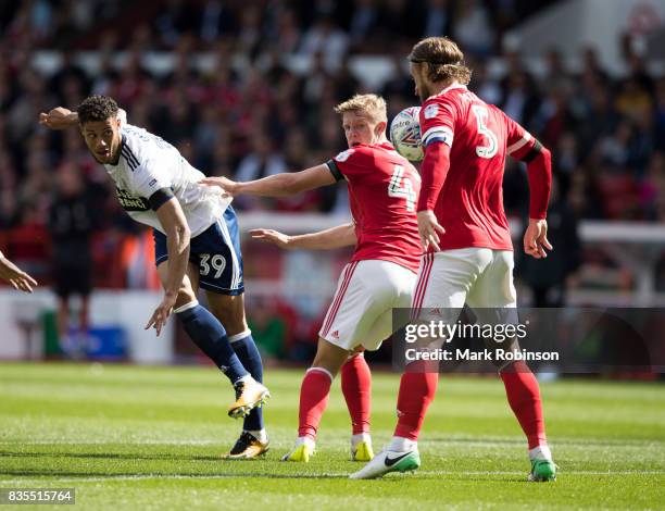 Rudy Gestede of Middlesbrough ahas his shot blocked by Matt Mills of Nottingham Forest during the Sky Bet Championship match between Nottingham...