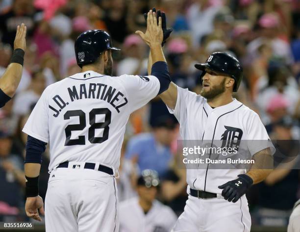 Tyler Collins of the Detroit Tigers celebrates with J.D. Martinez of the Detroit Tigers after hitting a three-run home run against the Baltimore...