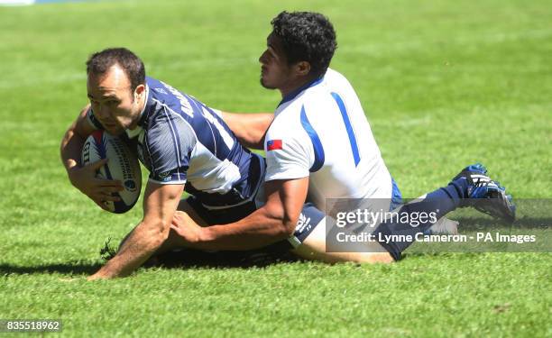 Scotland's Michael Adamson in action with Samoa's Alafoti Fa'osiliva during day two of the Emirates Airline Edinburgh Sevens Festival in the IRB...