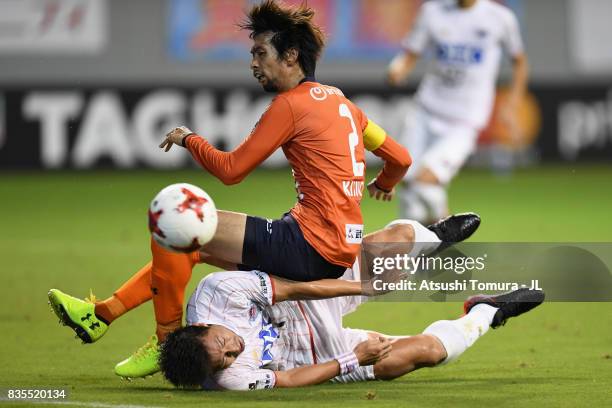 Kosuke Kikuchi of Omiya Ardija is tackled by Yohei Toyoda of Sagan Tosu during the J.League J1 match between Sagan Tosu and Omiya Ardija at Best...