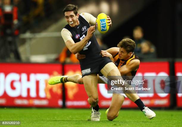 Jacob Weitering of the Blues is tackled during the round 22 AFL match between the Carlton Blues and the Hawthorn Hawks at Etihad Stadium on August...